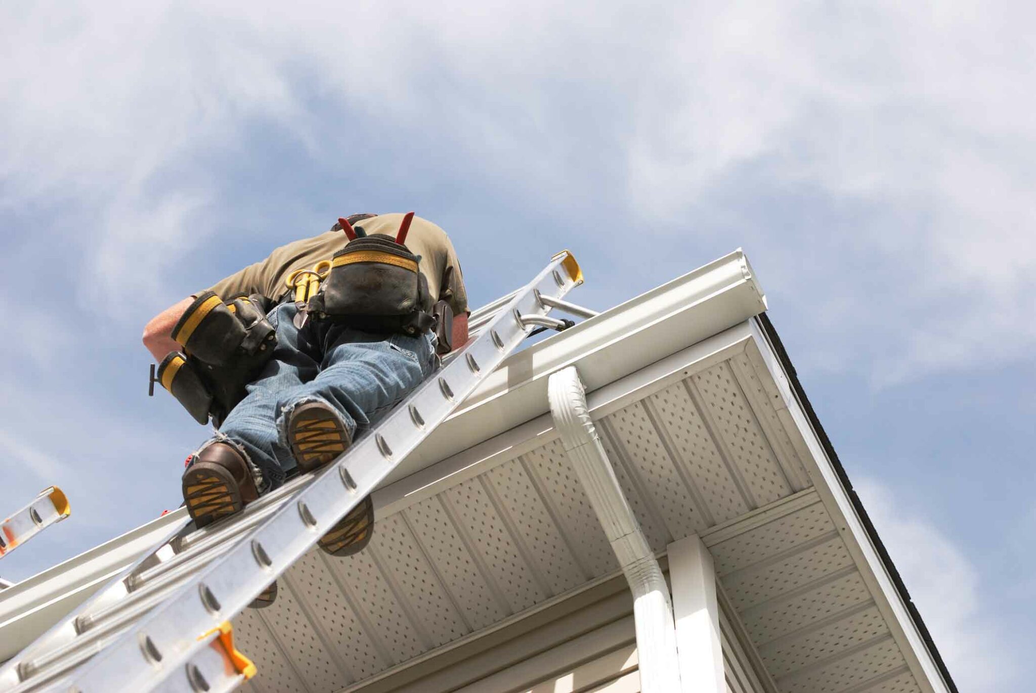 person up on ladder at roofline